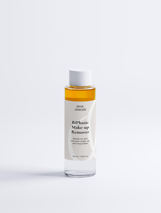 A transparent bottle of BiPhasic Make-up Remover with a white label, yellow liquid visible inside, and a pump dispenser.