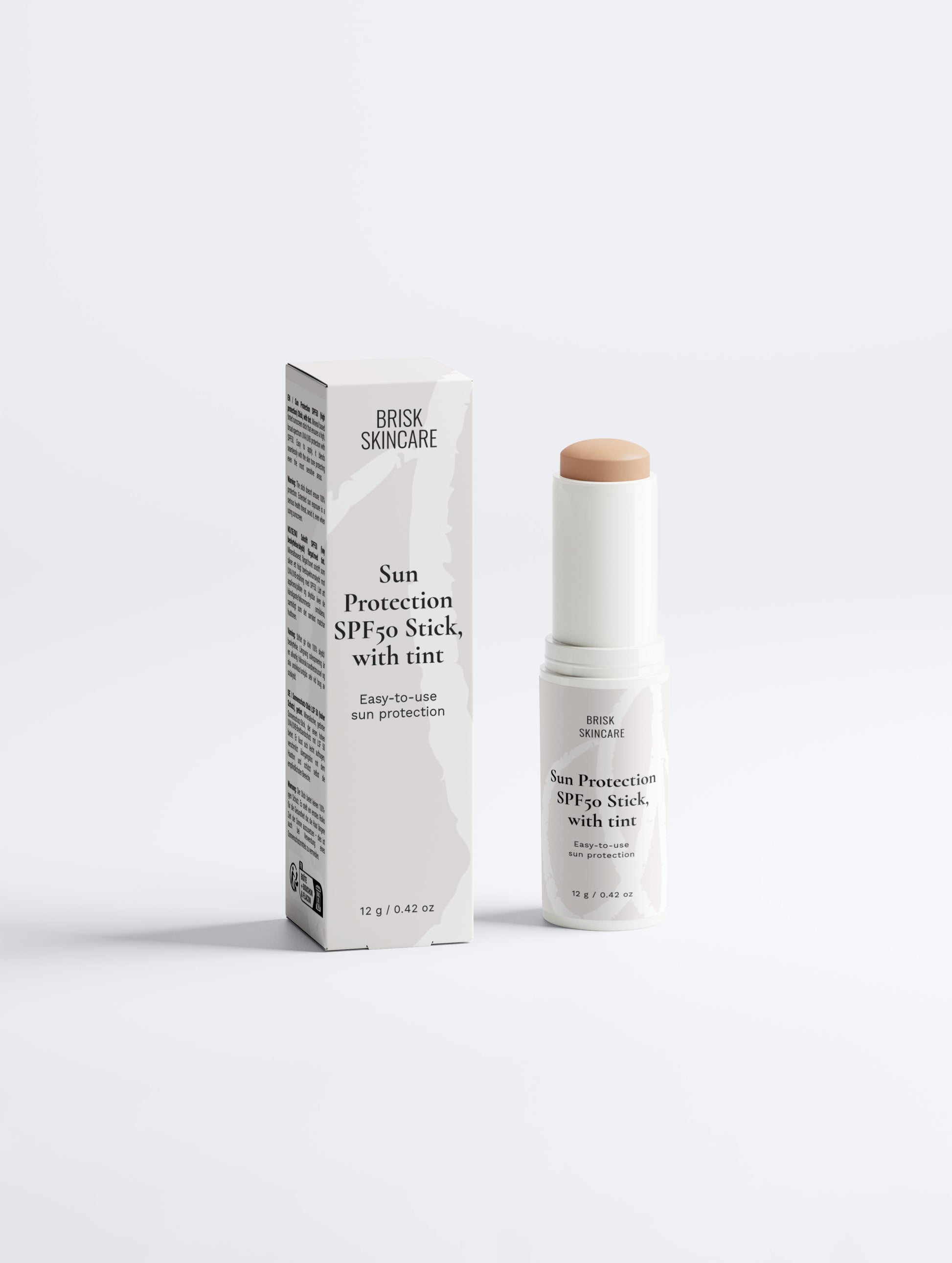 A sunscreen stick with its packaging, labeled as Sun Protection SPF50 with tint.
