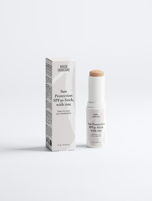 A sunscreen stick with its packaging, labeled as Sun Protection SPF50 with tint.
